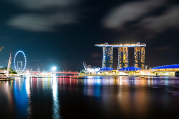 Fototapeta na wymiar Picturesque panoramic view of Singapore city at night time. Financial and trading center hub in Asia region. Concept of success. Modern buildings in high-tech world.