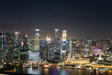 Fototapeta na wymiar Picturesque panoramic view of Singapore city at night time. Financial and trading center hub in Asia region. Concept of success. Modern buildings in high-tech world.