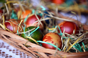 Colorful Easter eggs in a bowl on the table. Beautiful holiday decoration.