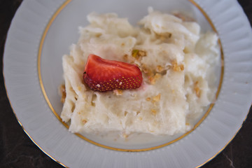 Traditional Turkish Ramadan Dessert Gullac . It is made with gullac (rice wafer or rice paper sheets) , milk, rose water, walnut, vanilla.