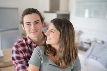 young couple smiling facing camera