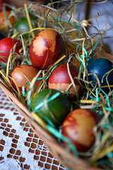 Colorful Easter eggs in a bowl on the table. Beautiful holiday decoration.