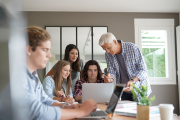 group of students working with a teacher