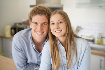 young couple smiling facing camera