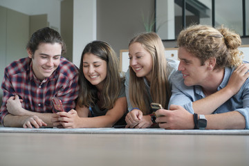 group of four young people with their phone