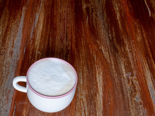 Cappucino on an old wooden table