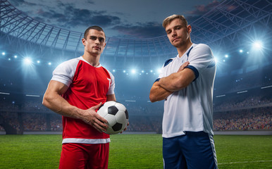 Two football players of different teams. They wear sportswear without a brand. Stadium and crowd...