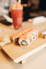 Fresh delicious Philadelphia sushi on wooden table