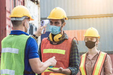 Worker is checking fever of his colleagues