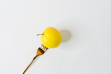 Healthy diet. Weight control. Apple on fork against white background. Healthy food concept. 