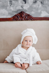 cute baby girl in white bathrobe