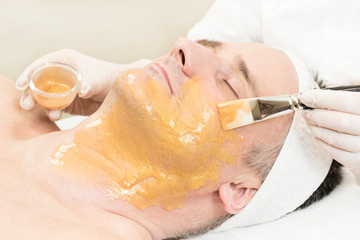 Man in the mask cosmetic procedure in spa salon 
