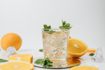 Fototapeta premium Sliced orange fruit segments isolated on white, lemonade