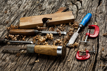carpenter tools on dark wooden pine wood table.