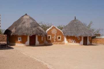 Fototapeta na wymiar Khuri village with traditional-style hut with clay-and-dung walls and thatched roofs, Jaisalmer, Rajasthan, India