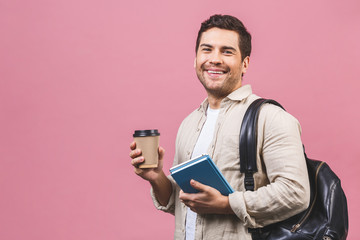 Young handsome man with backpack holding coffee cup isolated on pink background. Smiling student portrait. Studio shot of cheerful men going on travel.