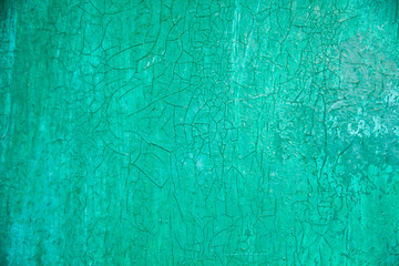 close-up cracked green background. grunge texture, decorative emerald wooden background. free space, place for text
