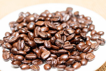 Cup of coffee with coffee beans on old background
