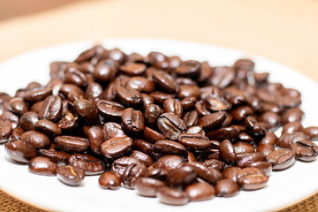 Cup of coffee with coffee beans on old background