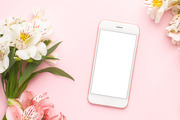 Mobile phone and white flowers Alstroemeria on a pink background