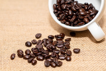 Cup of coffee with coffee beans on old background