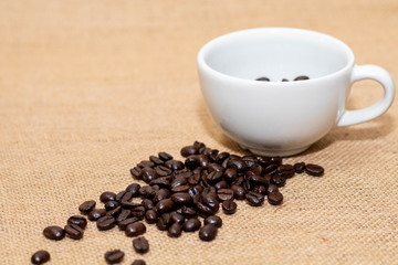 Cup of coffee with coffee beans on old background
