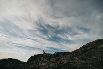 Norway. The couple holds hands and watches the scenery.
