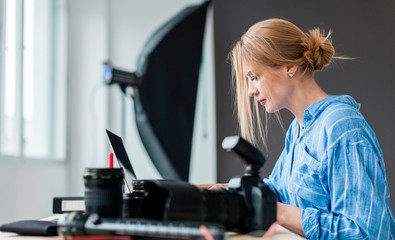 Sideways photographer woman working on her bench