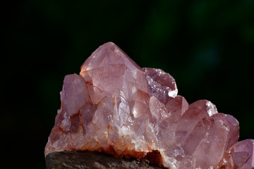 Huge amethyst among nature and many trees
