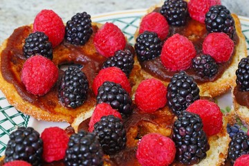 Raspberry and blackberry tarts on apple donuts
