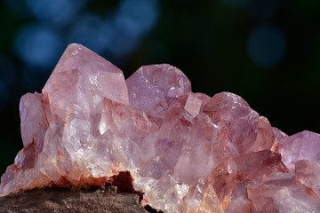 Huge amethyst among nature and many trees