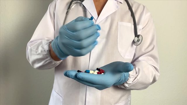 pharmacist, doctor in uniform holds pills, pills, new medicine, dietary supplement, concept of medicine, treatment of coronavirus, COVID-19