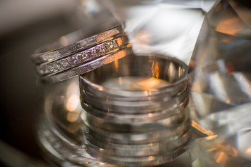 Obraz na płótnie Canvas Close-up of two Wedding rings on a diamond shaped crystal or glass on a weddings day 