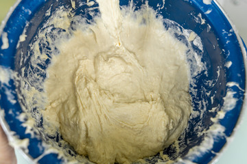 yeast dough mixed in a blue barrel. culinary background