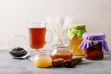 Glass cup of black tea served with honey