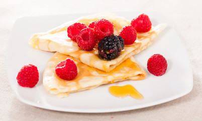 pancakes with raspberries, blackberries and honey
