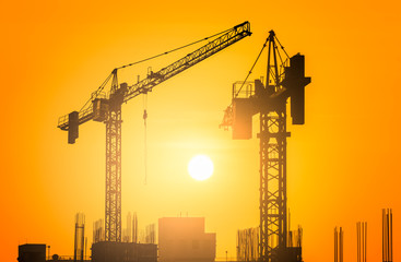 silhouette of construction crane on sunset