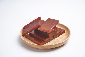 Hawthorn candy is placed in a wooden bowl. In a white background, it can be appetizing enough to make children like to eat and vegetables.