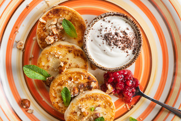 Delicious cottage cheese pancakes with lingonberry jam, nuts