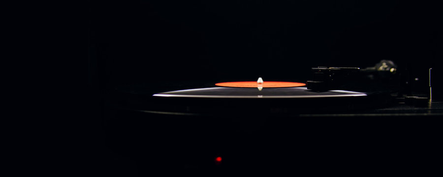 Turntable and vinyl records on a dark background