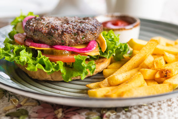 Tasty burger with french fries
