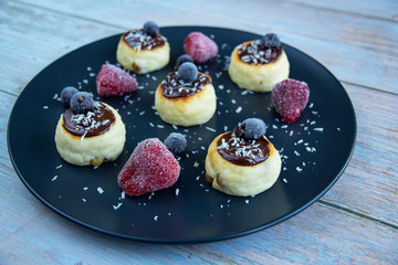 Cheesecakes with bitter chocolate and different berries