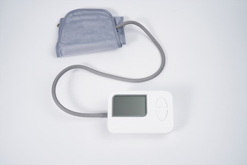 Electronic blood pressure monitor isolated against a white background