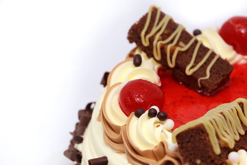 Close up chocolate cake with with red cherry on top, cream cake on white background