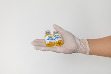 Doctor hand holding vial with medication, closeup. Vaccination and immunization