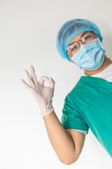 happy male doctor with medical mask in hospital showing ok hand sign, safety sign.