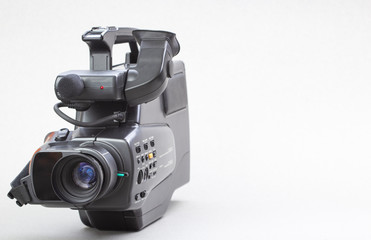 The video camera with the microphone isolated on white, in concept of technology, entertainment....