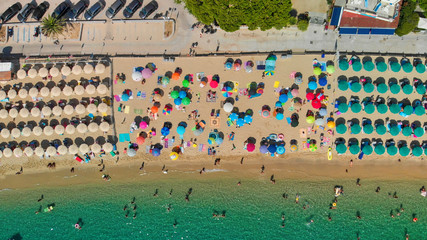 Aerial overhead view of lined beach umbrellas on a tropical beach