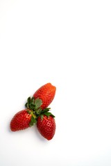 Red and fresh strawberries isolated on white
