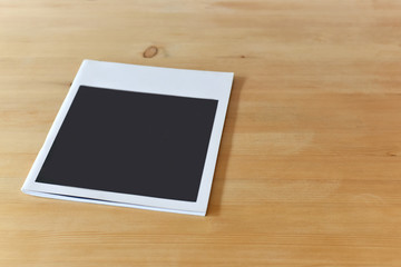 Blank book or magazine cover, catalog on wood background.